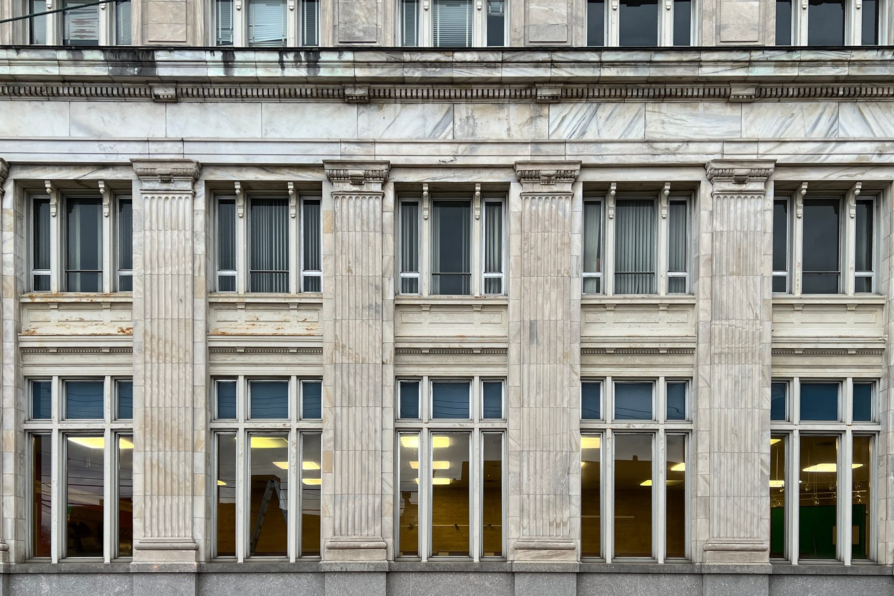 The stone and glass facade of a classical commercial building