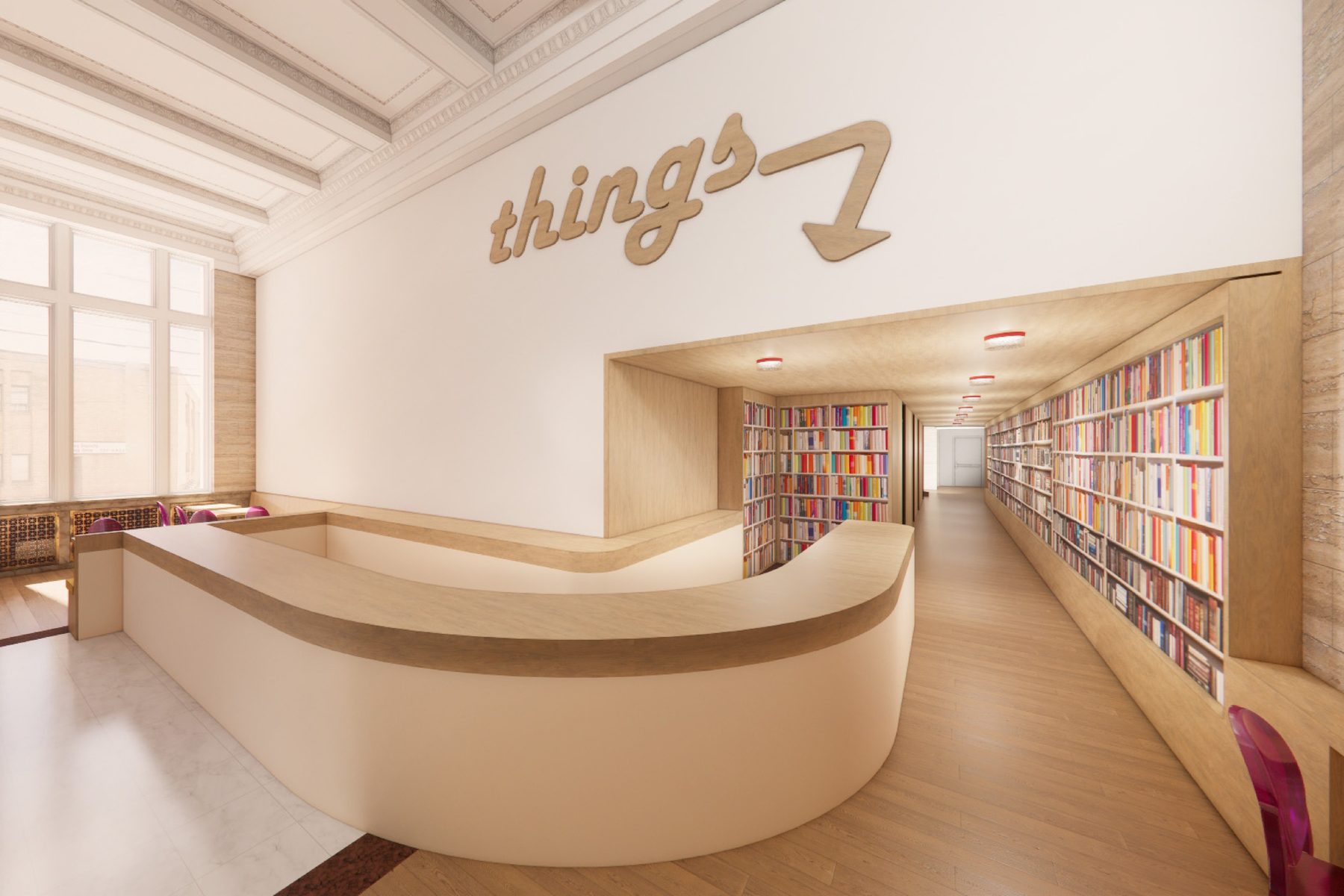 A curved reception desk in a white lobby, with lettering set into the wall